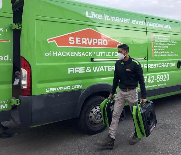 Always Prepared - male employee in front of green vehicles